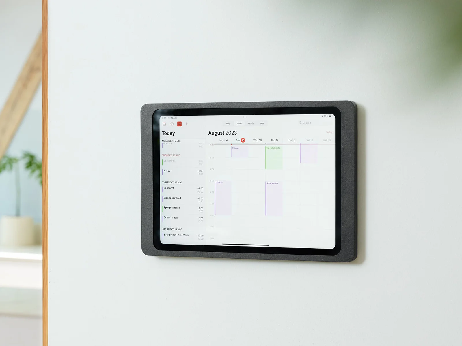 Displine Companion Wall 2.0 in black, mounted on a wall with an iPad showing a calendar
