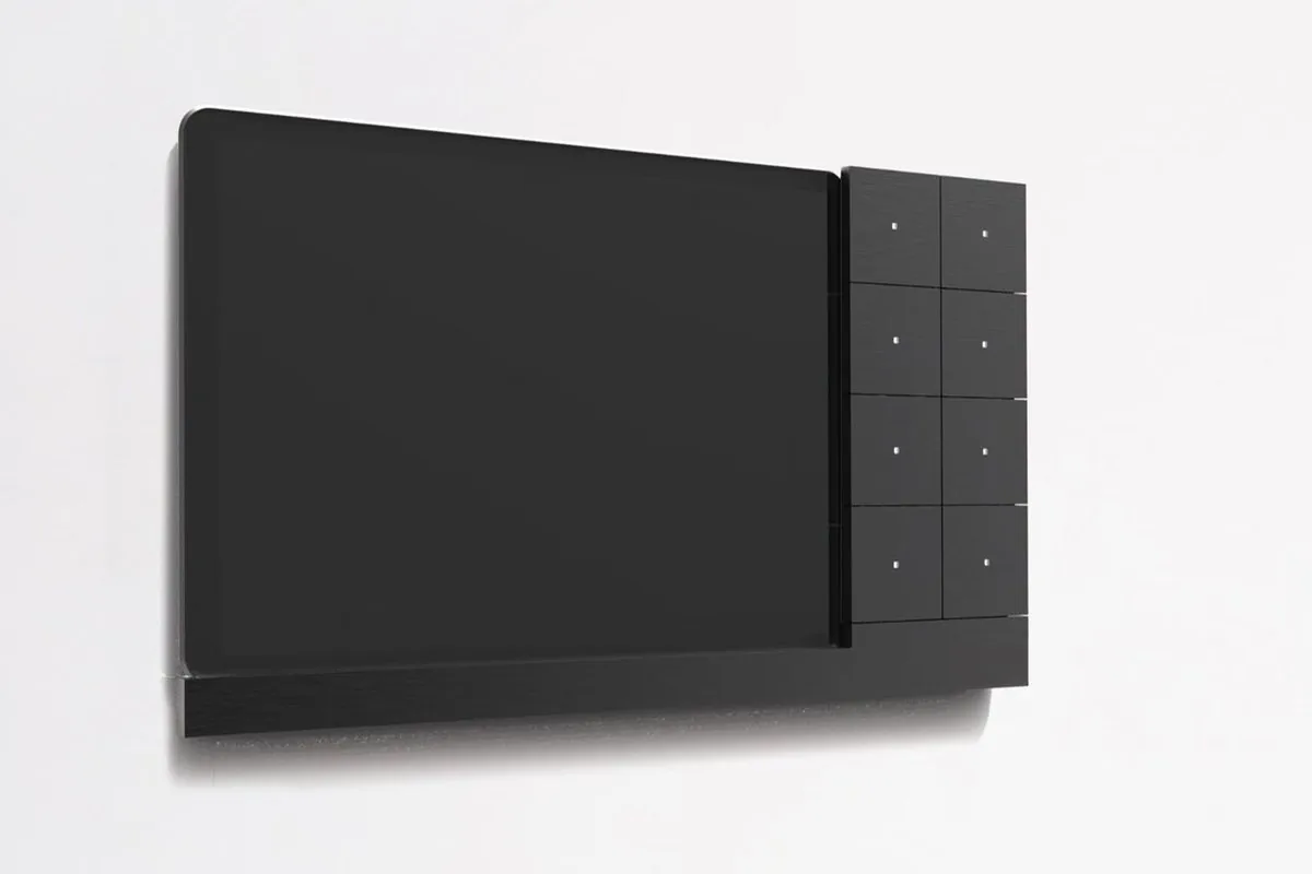 A black Eyeswitch on a white wall: a tablet holder with an eight-button Intensity strip beside it