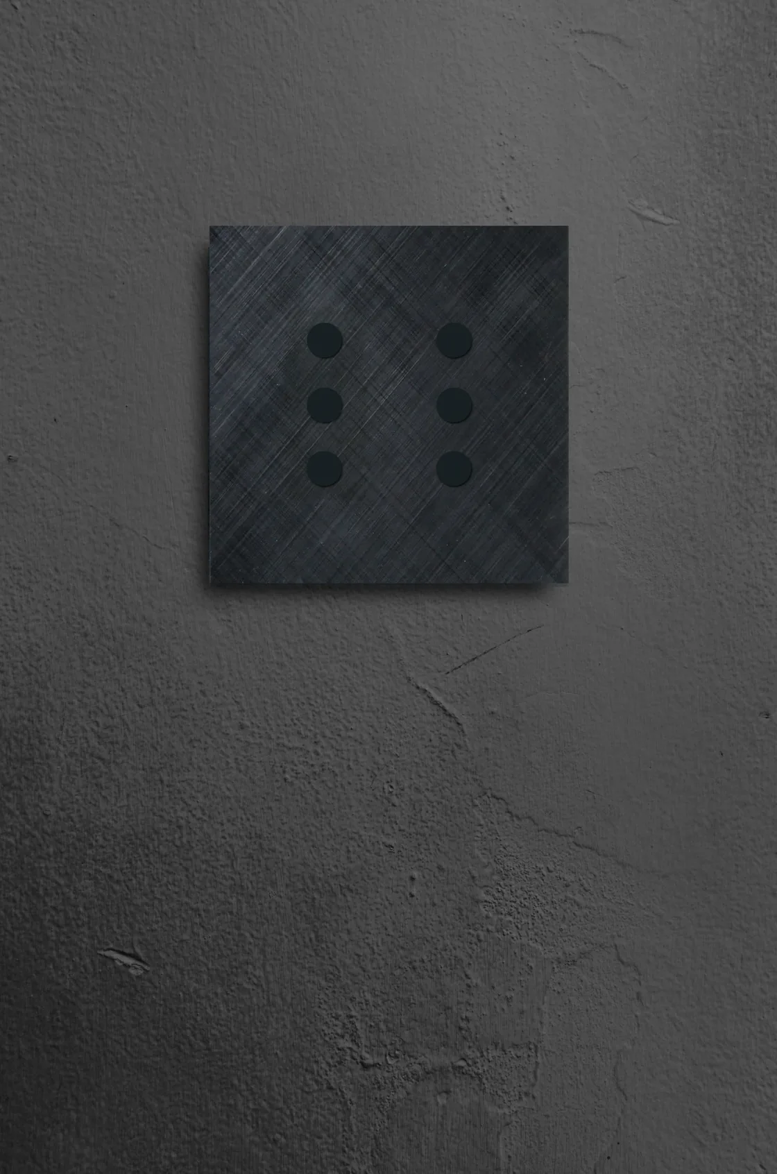 A black six-button Tense Serenity on a dark plaster wall