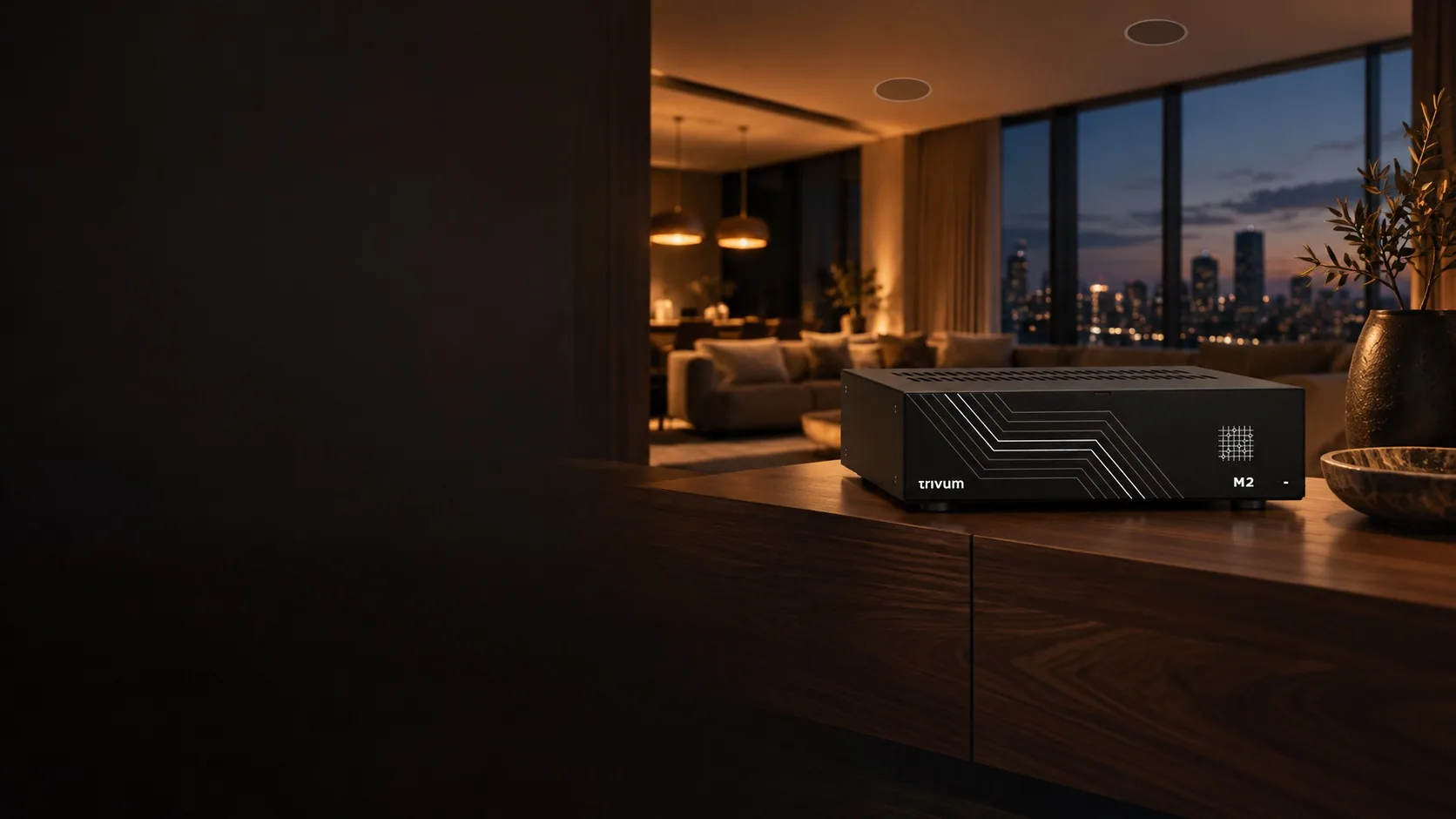 A Trivum M2 on a walnut console in a lounge at dusk, with round ceiling speakers above the sofa and the city lit up beyond the windows